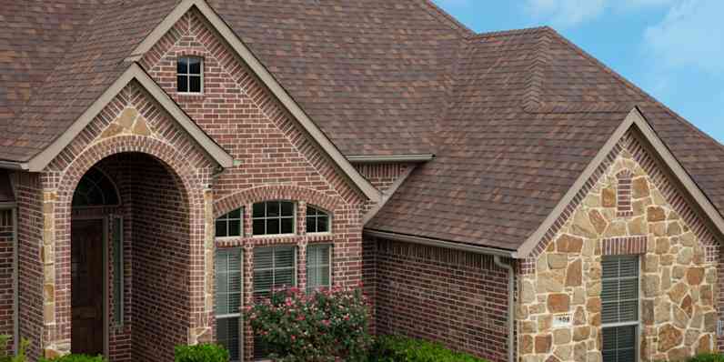 Home with red brick and stone exterior in various patterns and textures