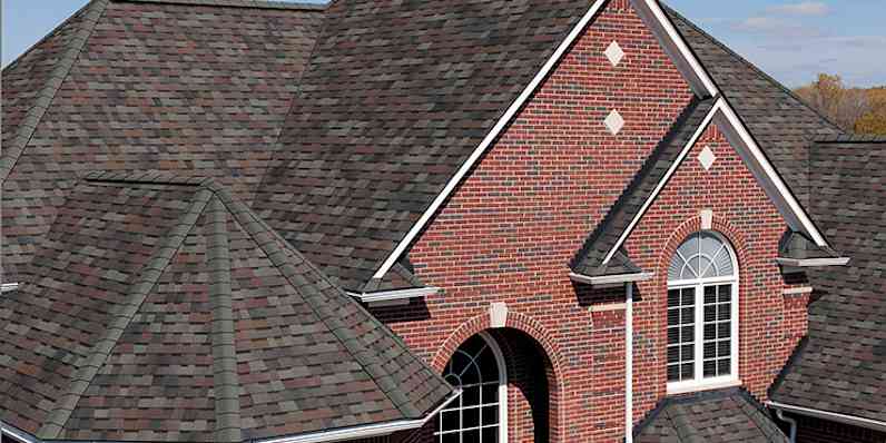 Photo of the top of a red brick house with TruDefinition® Duration® Shingles in Colonial Slate