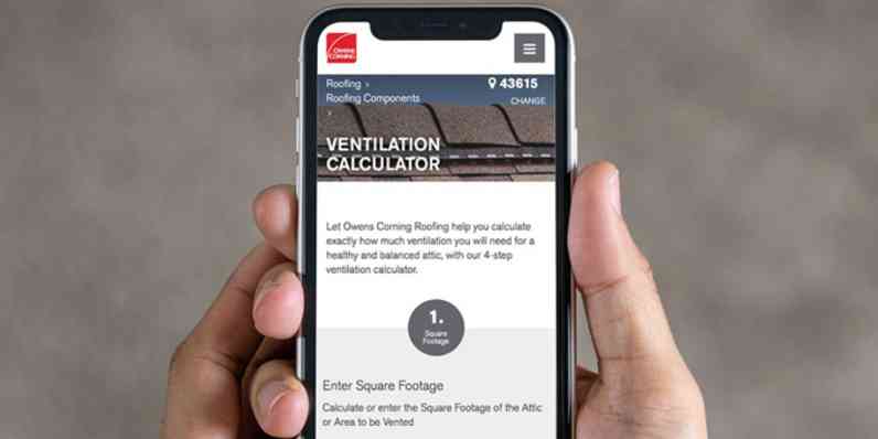Photo of a person's hand holding a phone, with the Owens Corning ventilation calculator on the screen