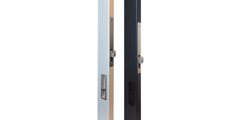 Close-up of modern sliding door lock system with recessed pull handle and integrated thumb turn in brushed stainless steel finish.
