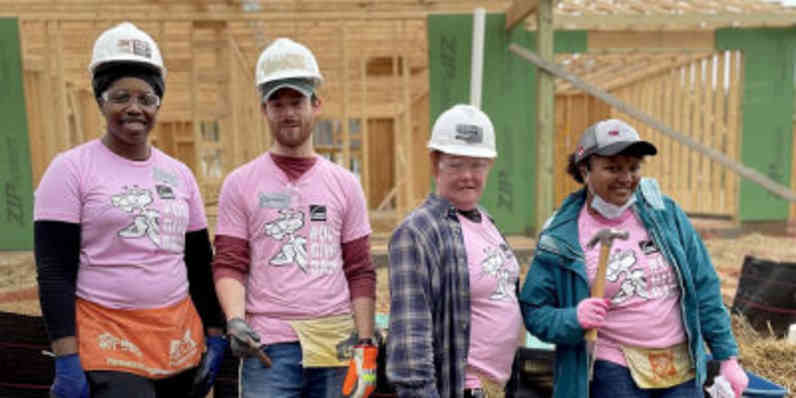 Owens Corning employees volunteering on a construction site