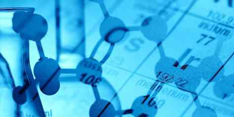 Chemical containers against a blue periodic table background