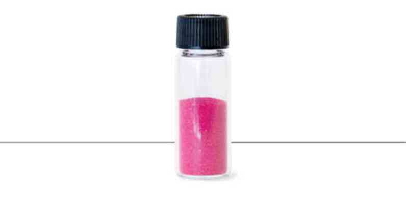 A vile of pink sand-like granules that are the color that is added to the PINK Next Gen™ Fiberglas®.