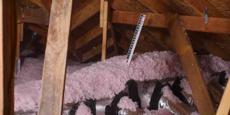 Attic showing buried ducts with several inches of insulation on top