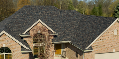 Tan brick home with Owens Corning Duration Designer shingles in Black Sable.