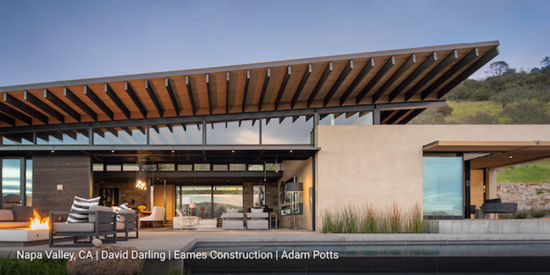 Modern house with big windows and glass doors.   