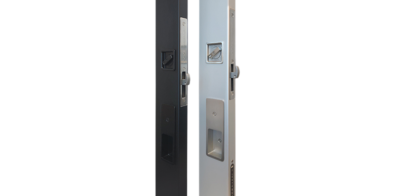 Close-up of modern sliding door lock system with recessed pull handle and integrated thumb turn in brushed stainless steel finish.
