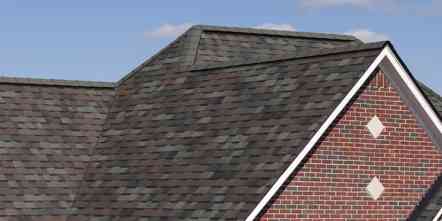Closeup of a roof on a red brick house