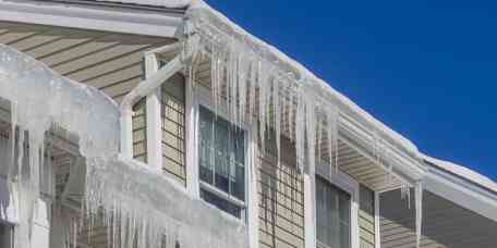 An ice dam is a ridge of ice that forms at the edge of a roof and prevents melting snowfrom draining off the roof.