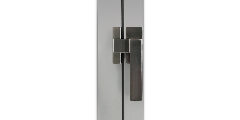 Close-up of modern stainless steel lever handle and lock mechanism installed on a sleek aluminum door frame, showcasing minimalist design and brushed finish.