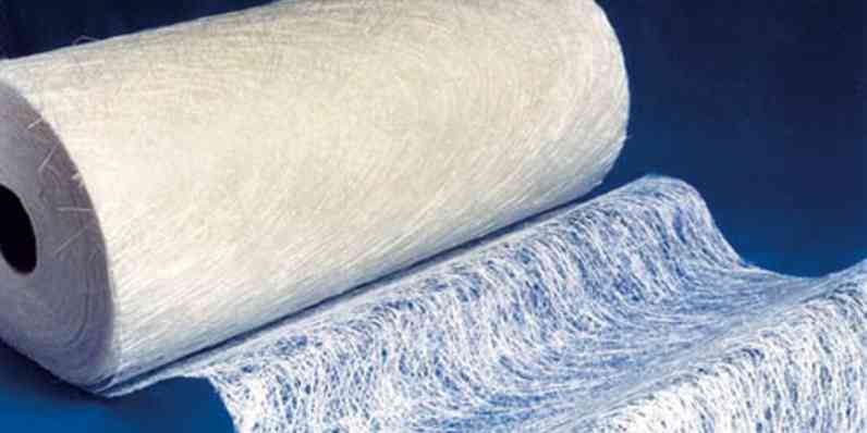 Roll of fiberglass mat with a section unrolled to show its loose, fibrous texture.