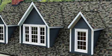 Home with blue siding and dormers with white trim and Owens Corning Trudefintiion Duration Designer shingles in Evergreen Mist.