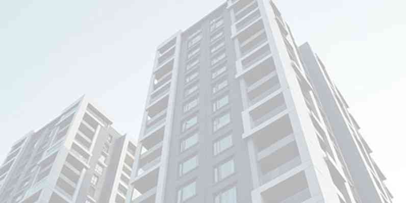 A building seen from beneath with the sky in the background.