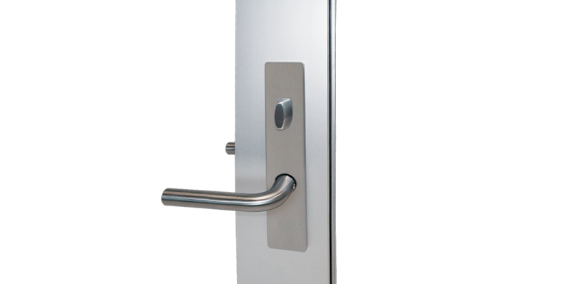 Stainless steel L-shaped door handle with a rounded corner and faceplate with oval lock knob for Fleetwood's 3900-T hinge door.