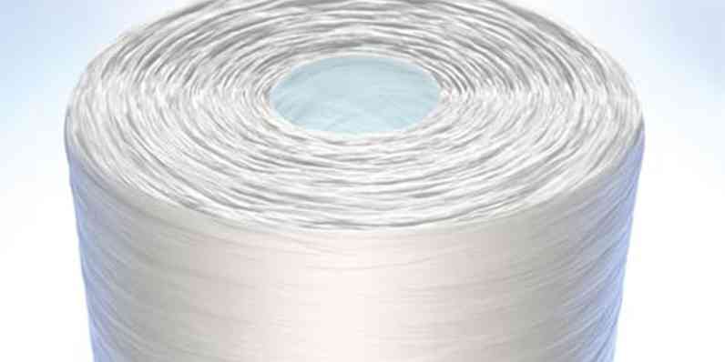 Close-up of a tightly wound white fiber spool with a hollow center.