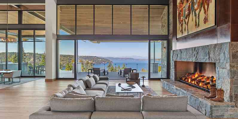 Living room with an open glass door overlooking the ocean.