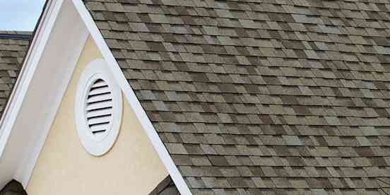 Closeup of a roof peak with Owens Corning Algae Resistant shingles.