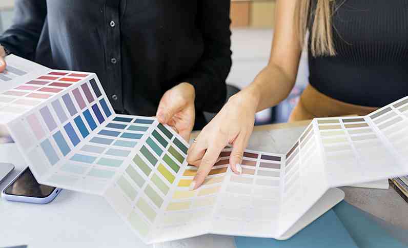 Two people looking at color swatches at a table