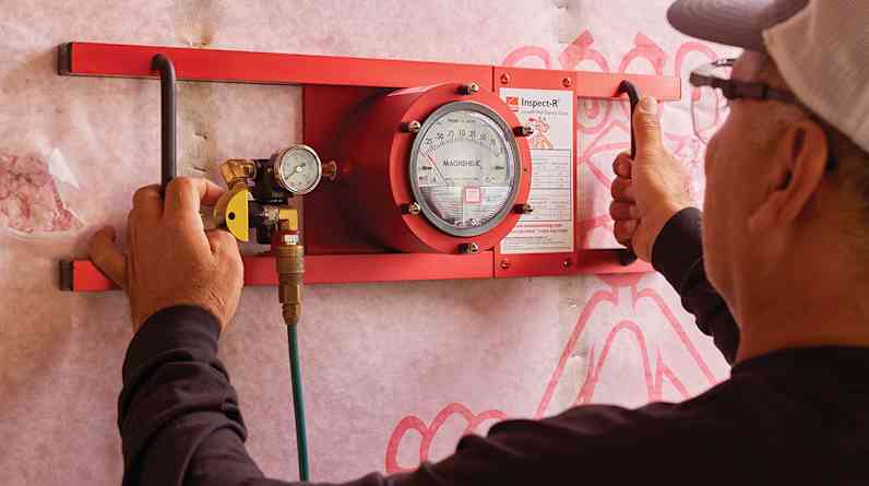 Worker testing insulation