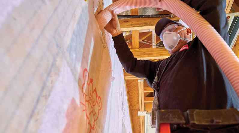 Contractor installing insulation