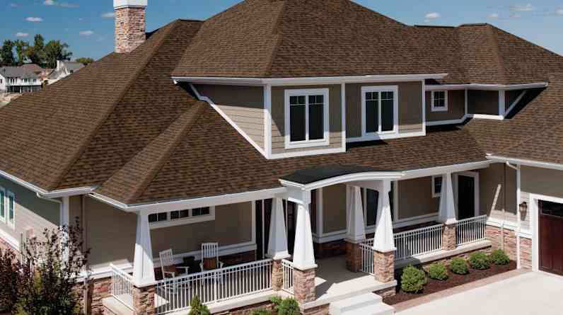 Photo of a tan house with brown Duration® Series Shingles on the roof