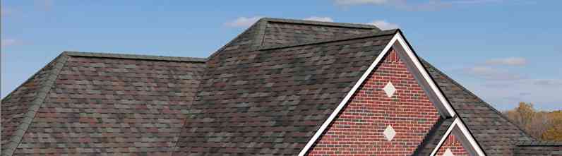 Closeup of a roof on a red brick house
