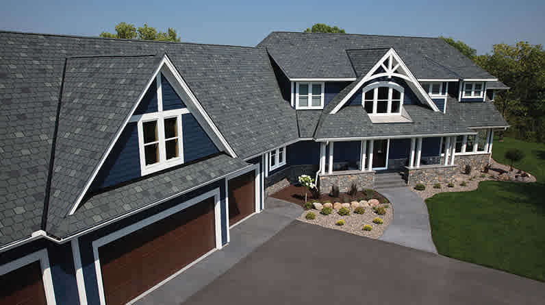 Photo of a dark blue house with dark gray/blue Berkshire® Shingles on the roof