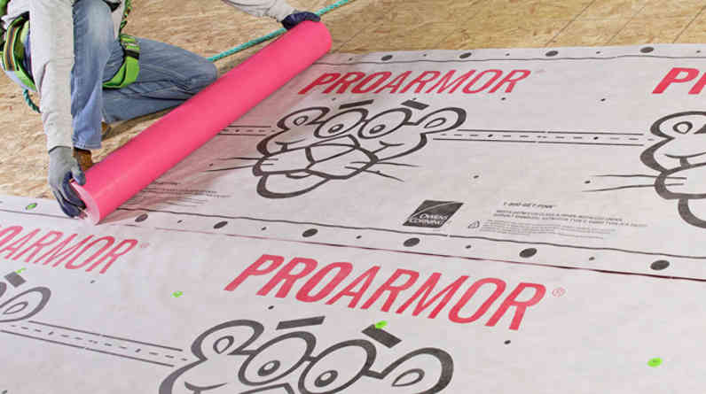 Photo of a contractor on a roof installing ProArmor® Synthetic Roof Underlayment