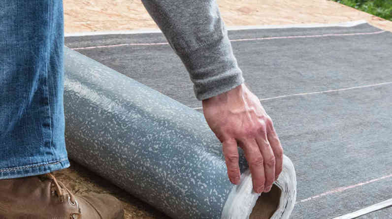 Closeup image of contractor installing WeatherLock® Mat Self-Sealing Ice & Water Barrier