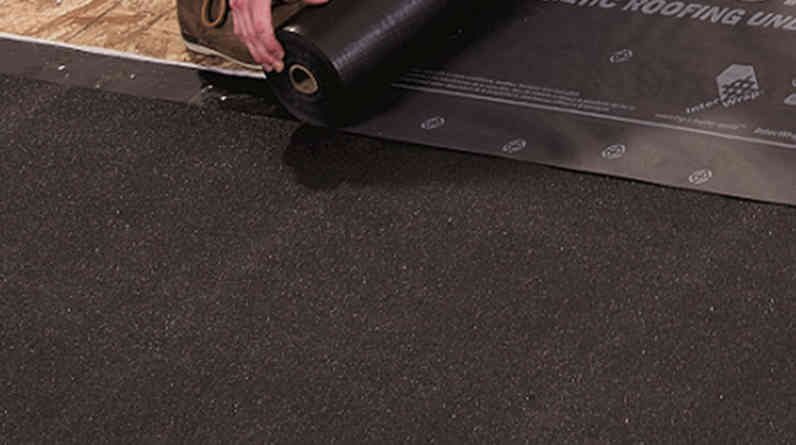 Closeup photo of contractor installing RhinoRoof® Granulated Self-Adhered Underlayment