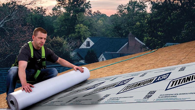 Photo of a contractor on a roof rolling out Titanium® X30 Premium Synthetic Underlayment