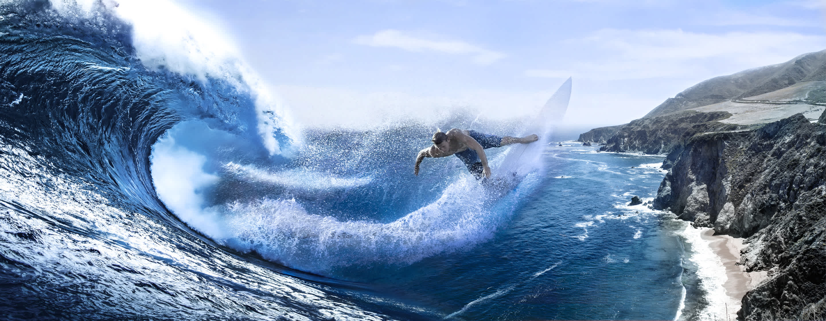 Man surfing in a curled wave composited atop a rocky coast leading to blue water with whitecap waves.
