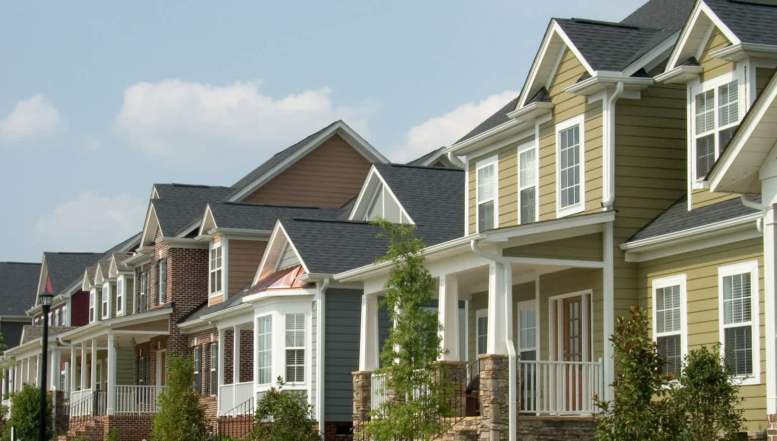 Colorful row of houses in a variety of shingle and brick colors