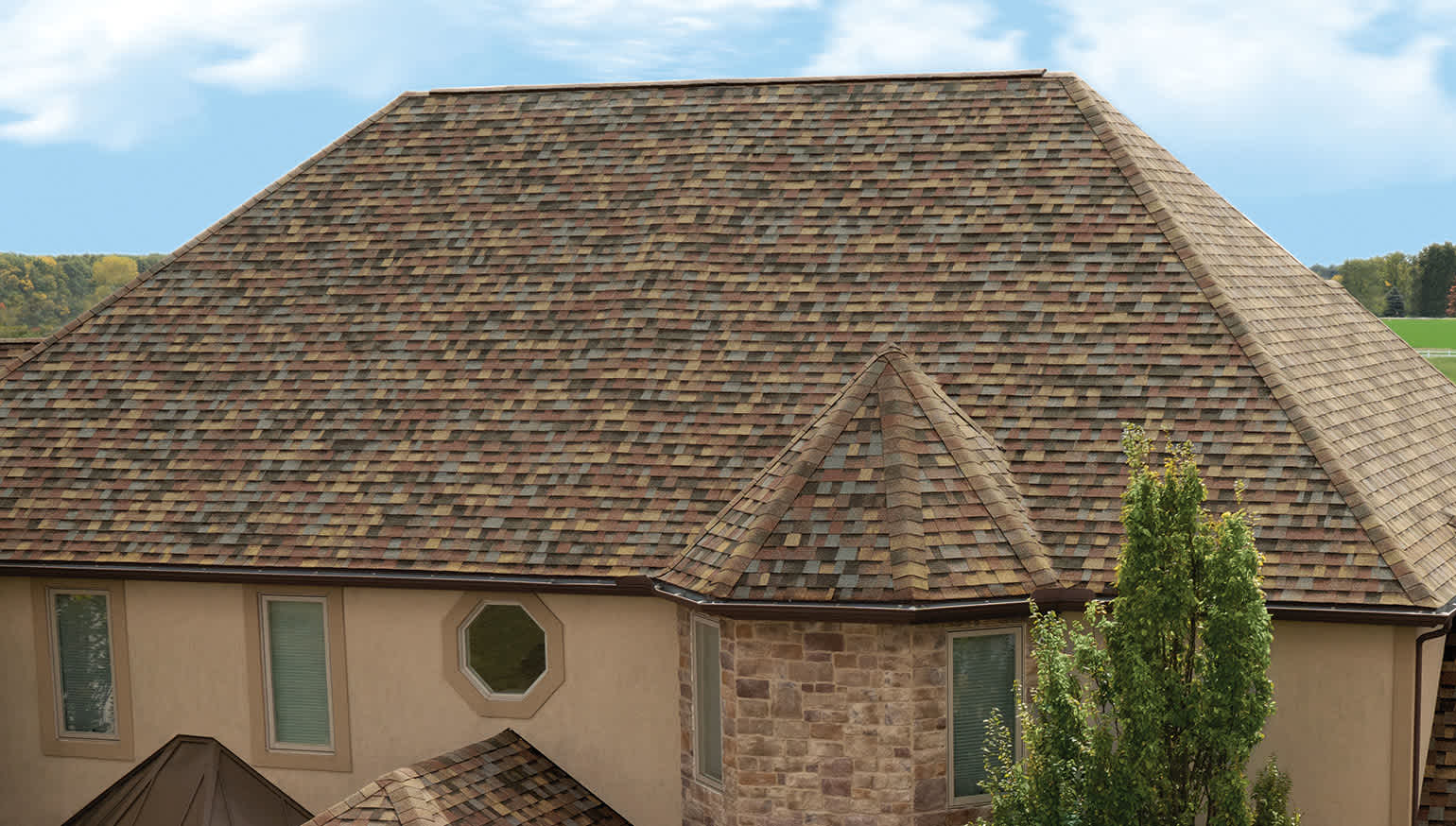 Tan house with TruDefinition® Duration FLEX® Shingles in the color Summer Harvest
