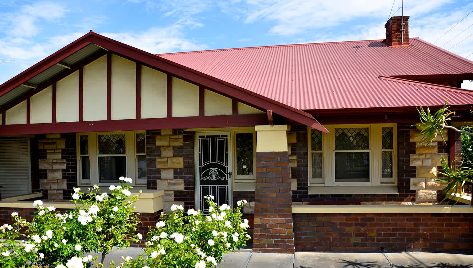 A 1920s Bungalow house with a red metal roof