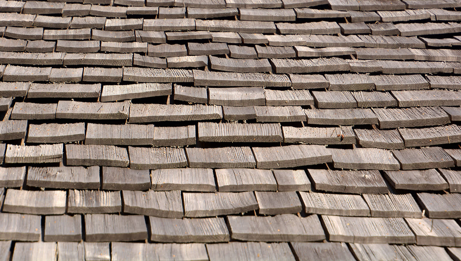 Photo showing how wood shake roofs may split and curl as they age