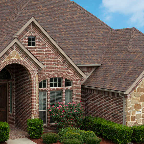 Home with red brick and stone exterior in various patterns and textures