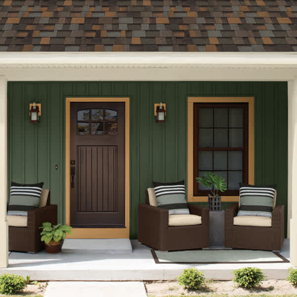 Front porch style with warm color palette featuring TruDefinition Duration Designer roof in the color Aged Copper