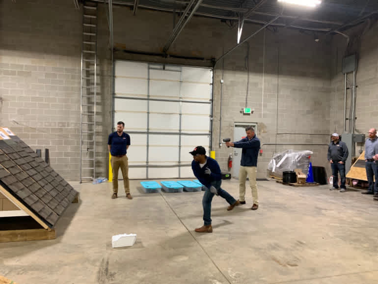 Contractor throwing ice ball at SBS roofing shingles