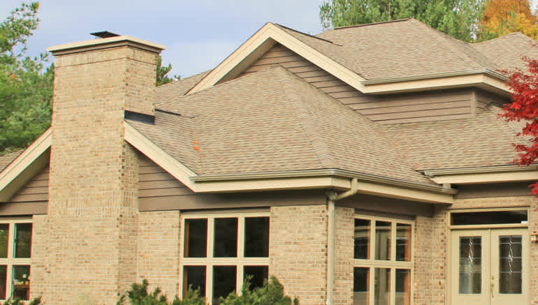Beige brick house with beige shingles