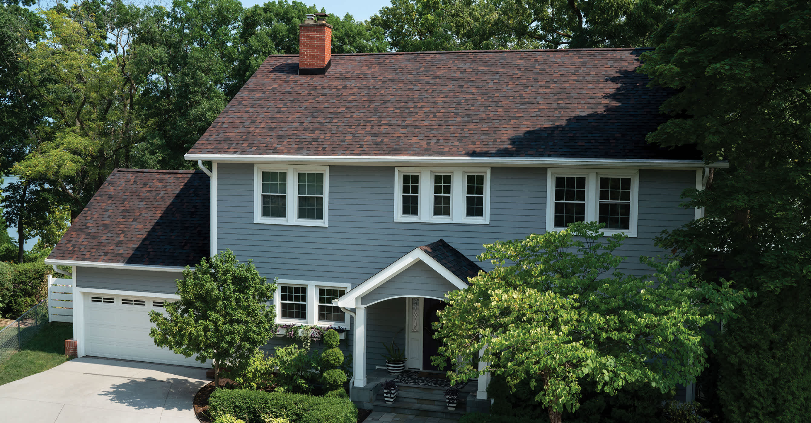 A two story house with bourbon brown colored roof