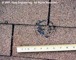 Hail damage to roofing shingles - closeup