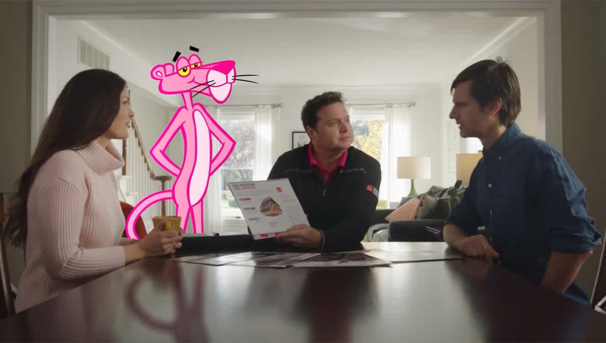 Contractor showing options to homeowners at the kitchen table with the Pink Panther