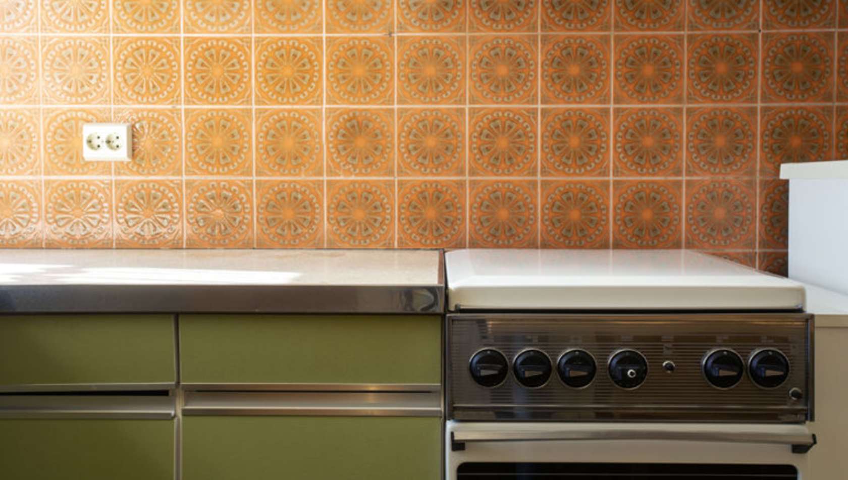 Vintage retro kitchen with orange pattern tiles, american retro kitchen home interior design 70's style close-up