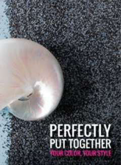 A seashell sitting on Pacific Wave colored granules with the words Perfectly put together.