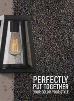 An modern light fixture sitting on Black Sable colored granules with the words Perfectly put together.