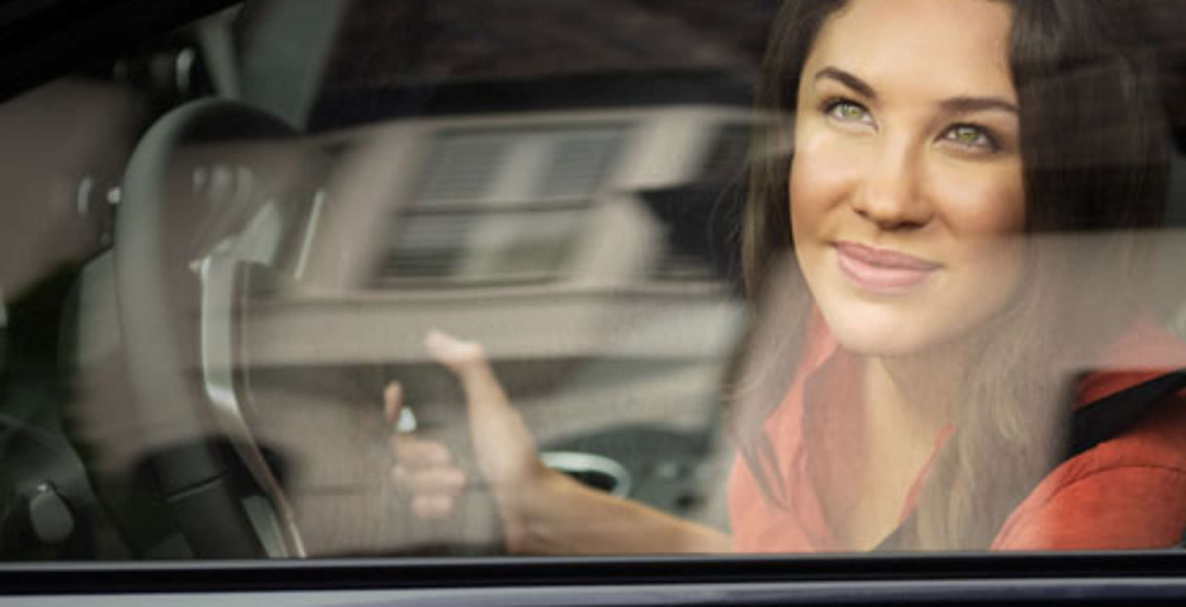 Photo of a woman looking out of her car window