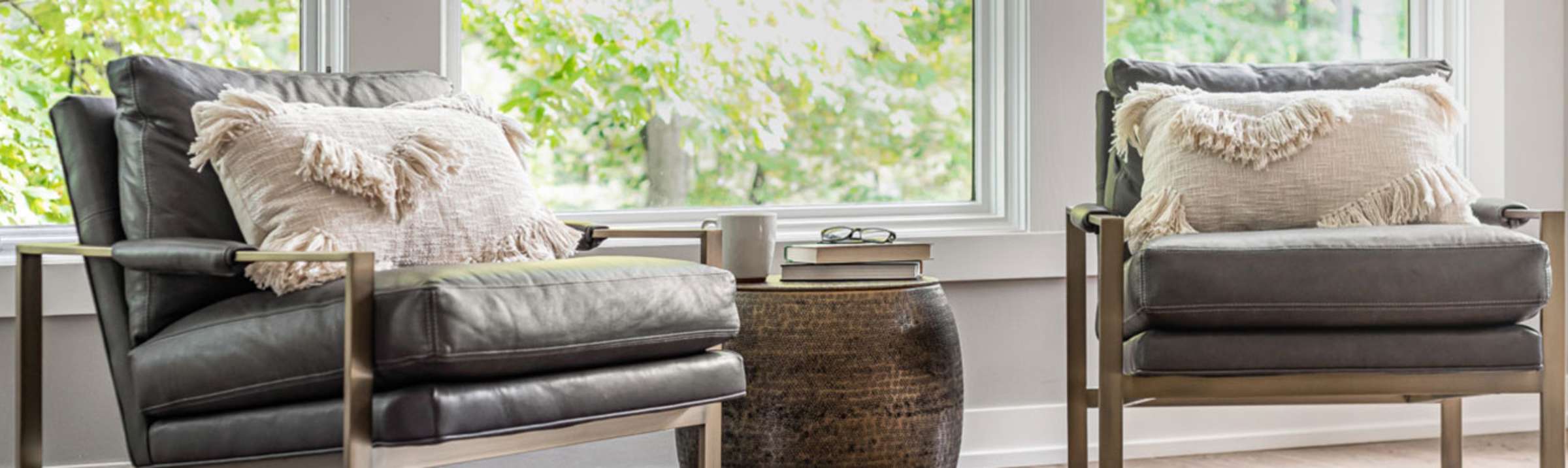Photo of two chairs sitting in front of windows in a home