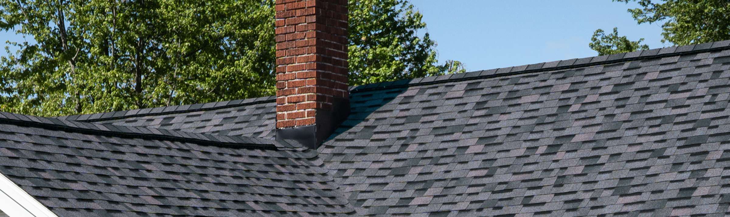 Close up view of roof line with Midnight Plum shingles from Owens Corning Duration shingle line