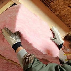batt of insulation being installed under floor